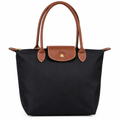 Longchamp style shoulder tote - black with brown trim, studio view